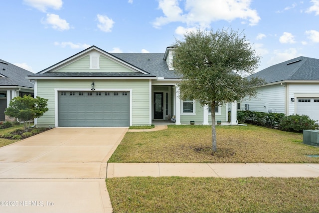 view of front of property with a garage, central AC, a shingled roof, concrete driveway, and a front lawn