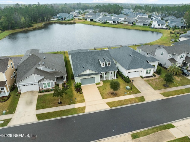 birds eye view of property featuring a water view and a residential view