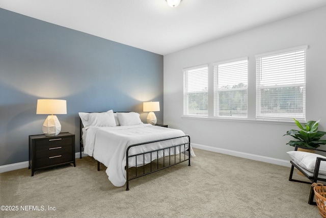 bedroom with carpet flooring and baseboards