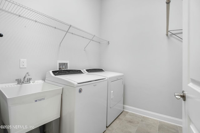 laundry room with independent washer and dryer, laundry area, a sink, and baseboards