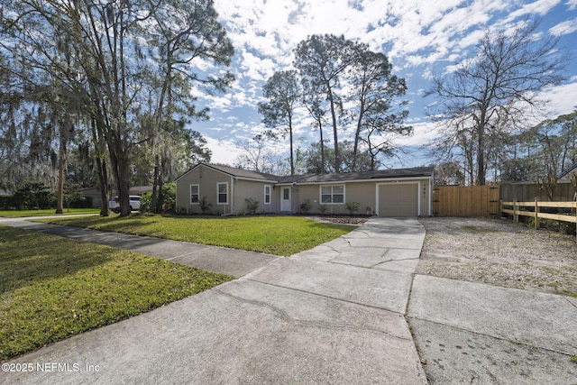 single story home with a garage, a front yard, driveway, and fence