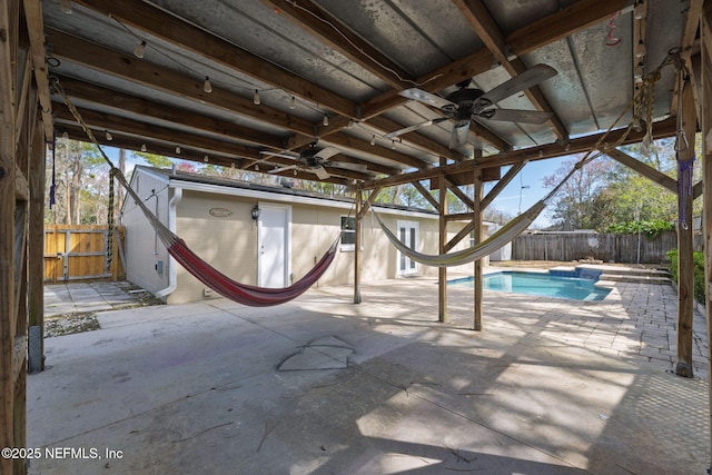 view of swimming pool with a fenced in pool, a fenced backyard, a patio, and ceiling fan