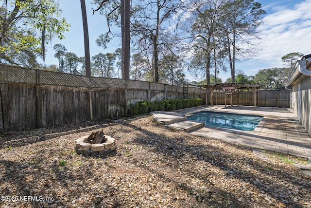 view of swimming pool featuring a fire pit, a patio, a fenced backyard, and a fenced in pool