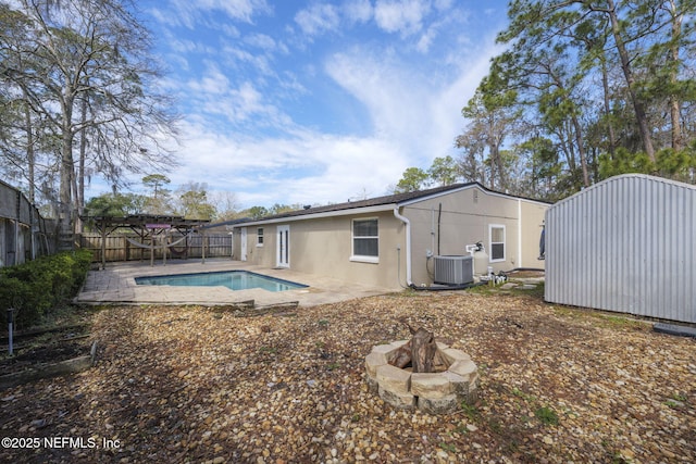 back of property with a fenced in pool, a patio, stucco siding, cooling unit, and a fenced backyard