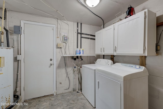 laundry room featuring concrete block wall, cabinet space, washing machine and clothes dryer, and water heater