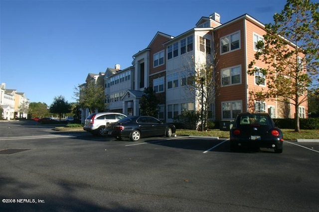 view of property with uncovered parking