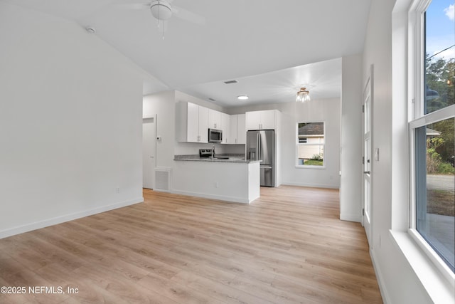 kitchen featuring light wood finished floors, visible vents, appliances with stainless steel finishes, and open floor plan