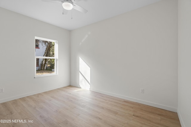 spare room featuring light wood-type flooring, ceiling fan, and baseboards