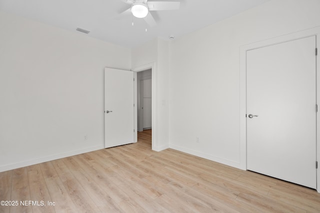 unfurnished bedroom with baseboards, ceiling fan, visible vents, and light wood-style floors