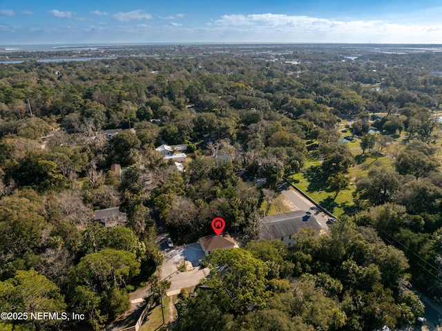 bird's eye view with a wooded view