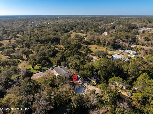 birds eye view of property with a view of trees