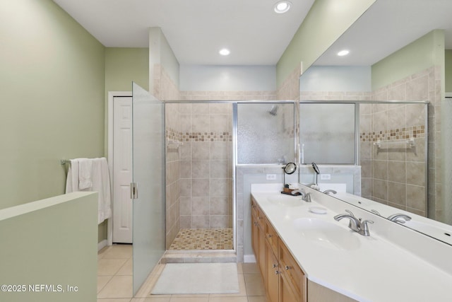 full bath featuring a stall shower, a sink, and tile patterned floors