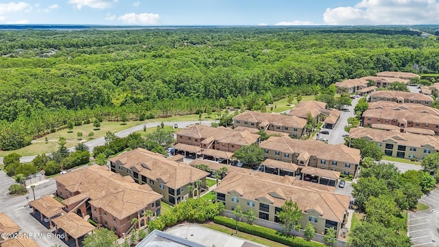 bird's eye view with a wooded view and a residential view