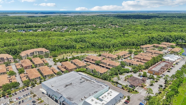 birds eye view of property featuring a residential view, a water view, and a forest view