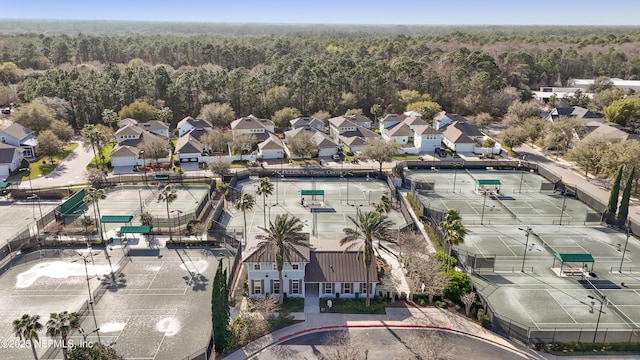 drone / aerial view featuring a forest view and a residential view