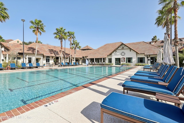 community pool featuring a patio area and a residential view