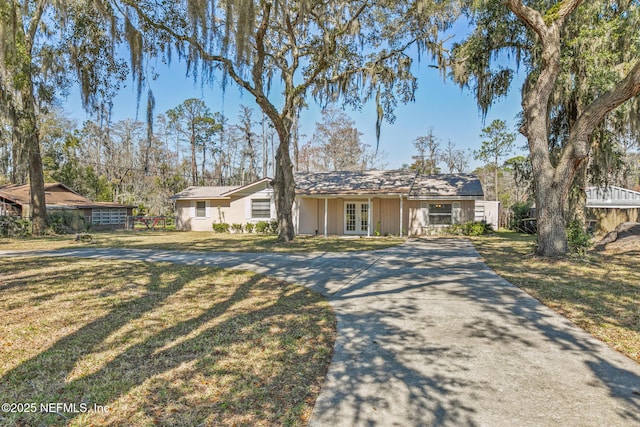 view of front of property featuring french doors and a front lawn