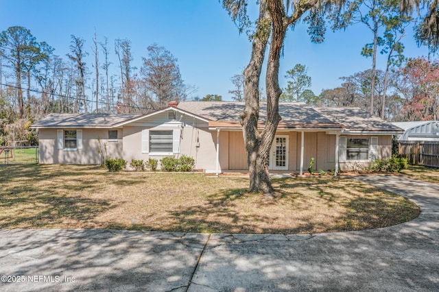 ranch-style home featuring a front yard, french doors, and fence