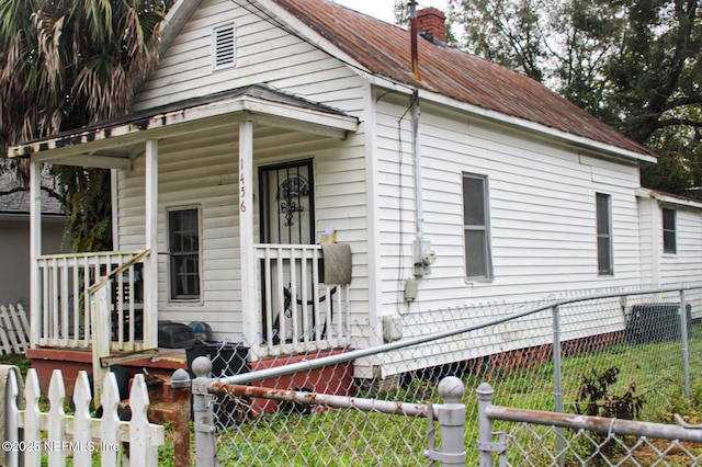 view of front of home featuring a chimney and fence