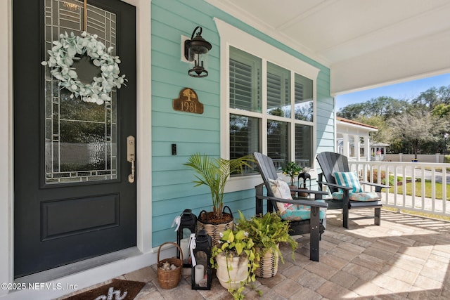 view of exterior entry featuring a porch