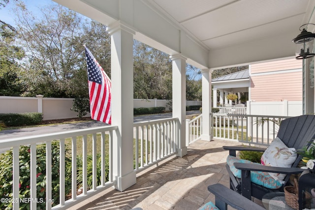 exterior space featuring fence and a porch