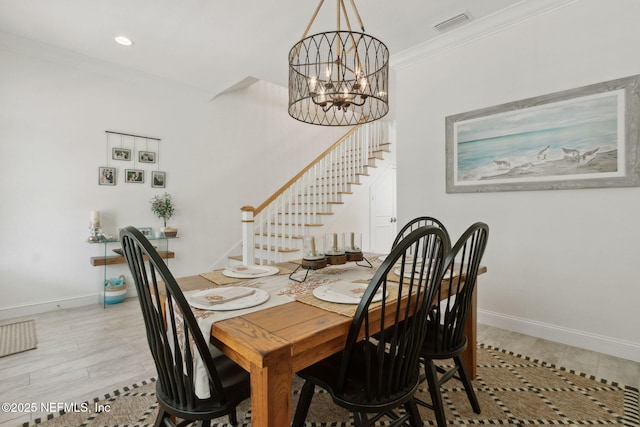 dining room with stairs, ornamental molding, baseboards, and an inviting chandelier