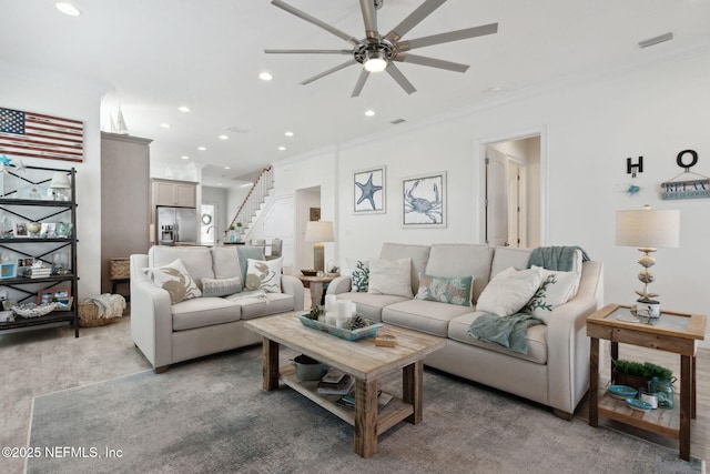 living room with crown molding, recessed lighting, visible vents, light wood-style flooring, and stairway