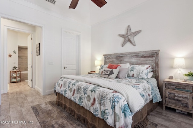 bedroom featuring baseboards, ornamental molding, and a ceiling fan