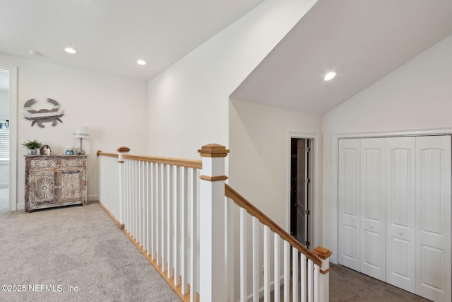 corridor featuring lofted ceiling, carpet floors, an upstairs landing, and recessed lighting