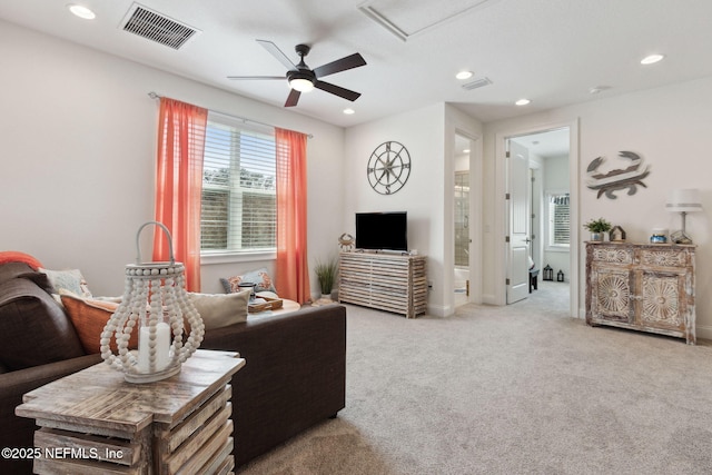 carpeted living room featuring visible vents and recessed lighting