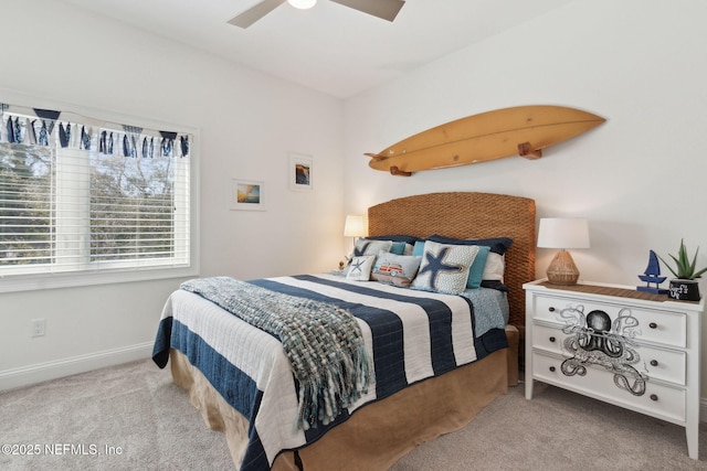 carpeted bedroom with a ceiling fan and baseboards