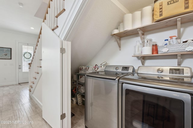 laundry room featuring laundry area, crown molding, baseboards, and separate washer and dryer