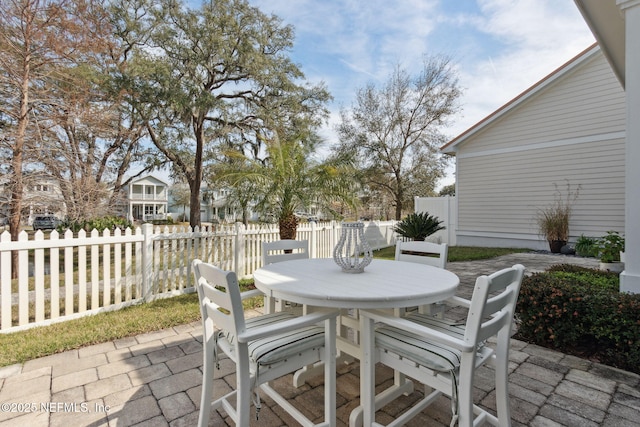 view of patio with outdoor dining area and fence