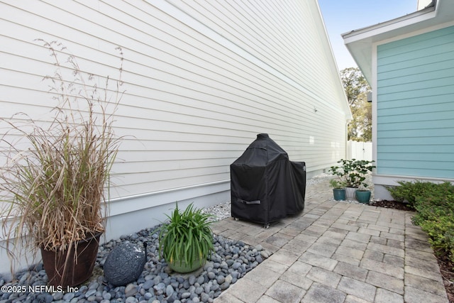 view of patio featuring grilling area and fence