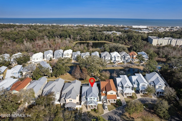 drone / aerial view featuring a water view and a residential view