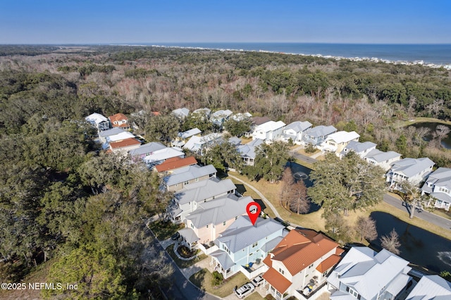 birds eye view of property with a water view, a wooded view, and a residential view