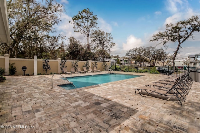 pool featuring a patio area and fence