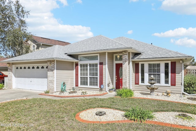 view of front of house featuring concrete driveway, a front lawn, roof with shingles, and an attached garage