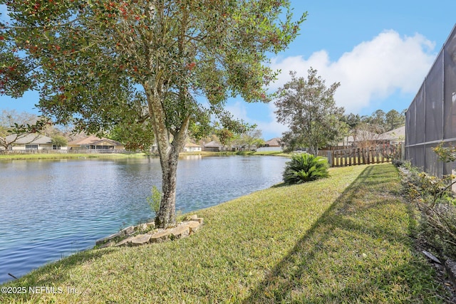 property view of water with fence and a residential view