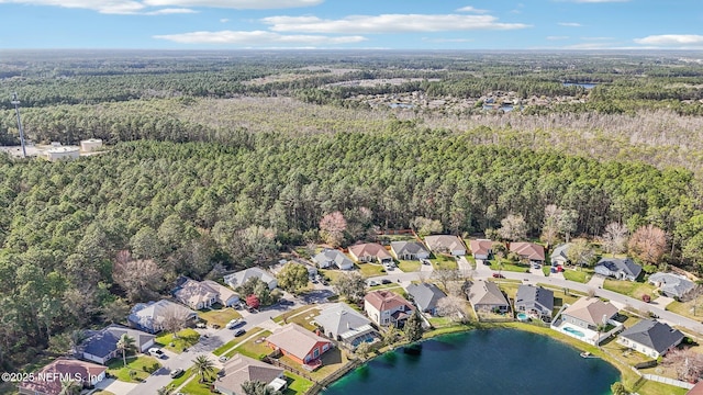 birds eye view of property featuring a forest view, a water view, and a residential view