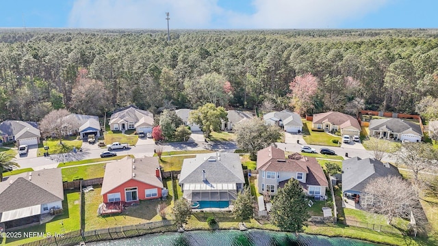 aerial view featuring a wooded view and a residential view