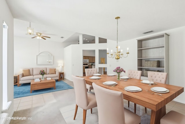 dining room with lofted ceiling, ceiling fan with notable chandelier, light tile patterned flooring, and visible vents