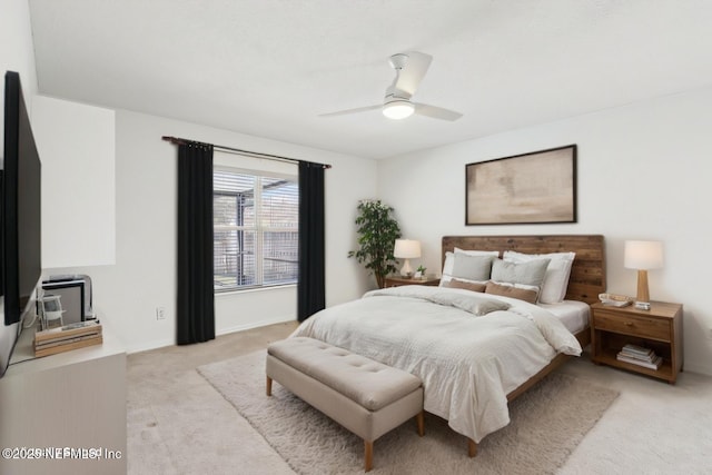 bedroom with ceiling fan, baseboards, and light colored carpet