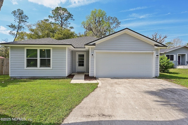 ranch-style home with a garage, a shingled roof, concrete driveway, and a front yard