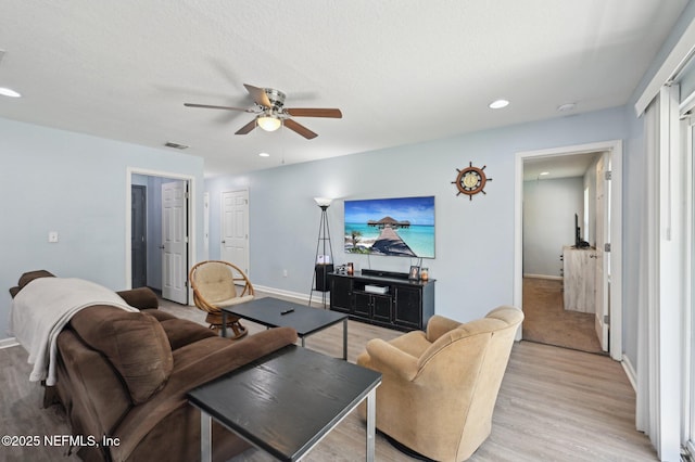 living room with light wood finished floors, recessed lighting, visible vents, a ceiling fan, and baseboards