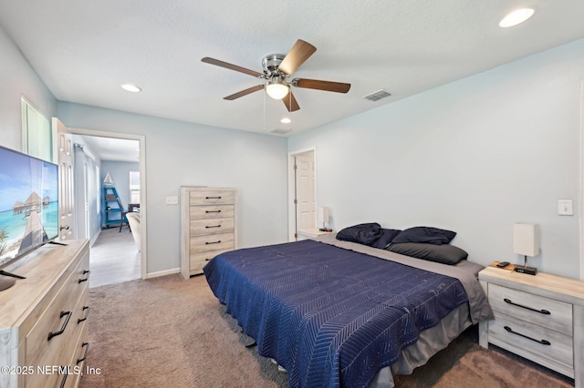 carpeted bedroom with ceiling fan, visible vents, baseboards, and recessed lighting