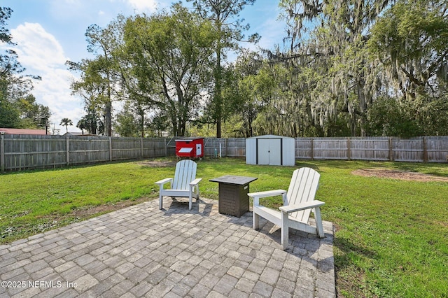 view of patio featuring a fenced backyard, an outdoor structure, and a shed