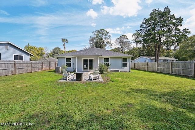 back of property featuring a fenced backyard, central AC unit, a patio, and a yard