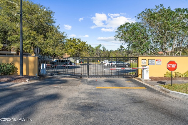 exterior space with a gated entry, traffic signs, and a gate