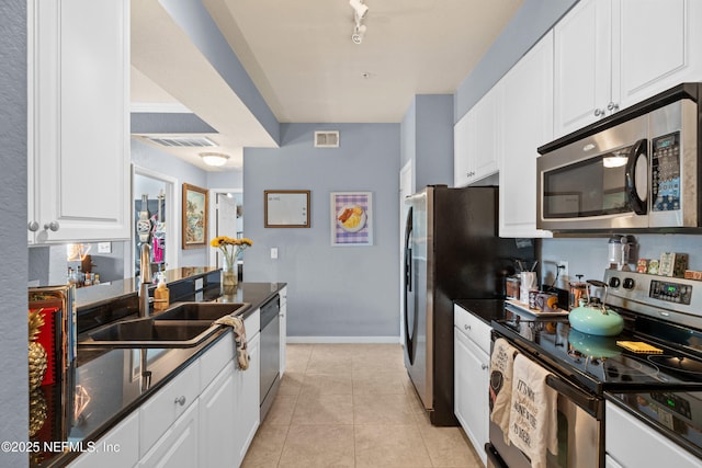 kitchen with light tile patterned floors, visible vents, appliances with stainless steel finishes, and a sink